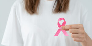 bigstock-Woman-Hold-Pink-Ribbon-Breast--476766343